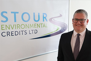 Lee Forman standing infront of the Stour Environmental Credits logo